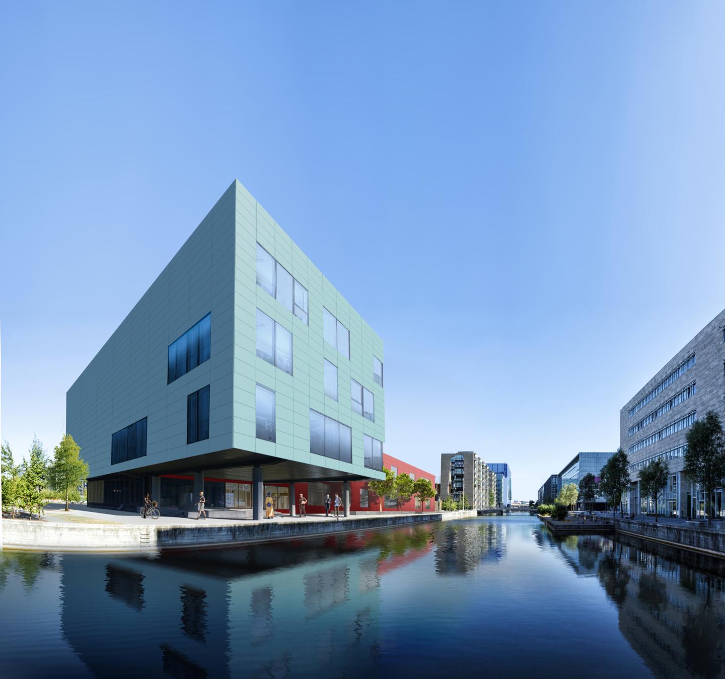 a building with the Fixade fastening system viewed from a distance, with water in the foreground.